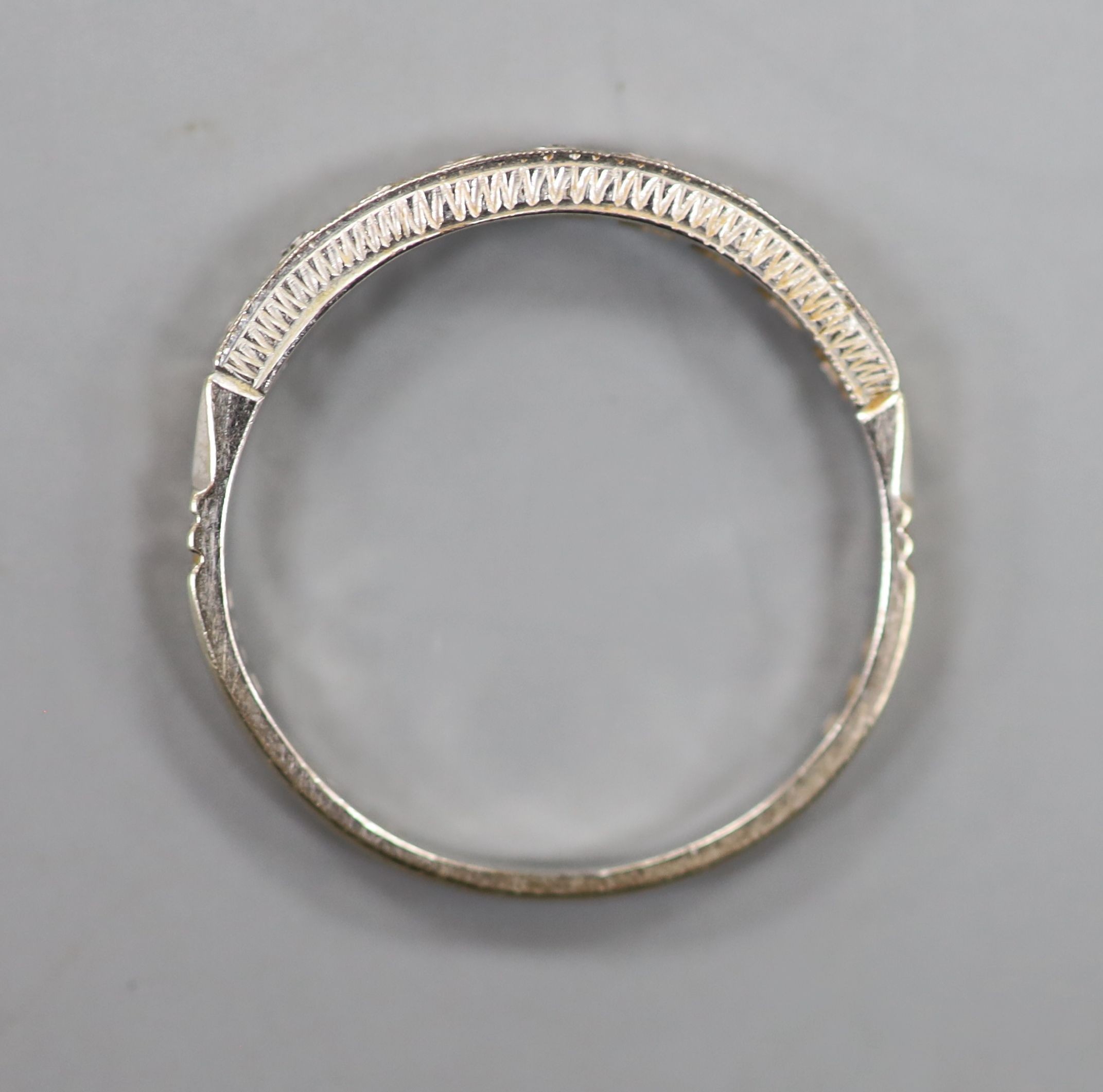 A modern 18ct white gold and diamond chip set half eternity ring. size Q, gross weight 2.5 grams.
